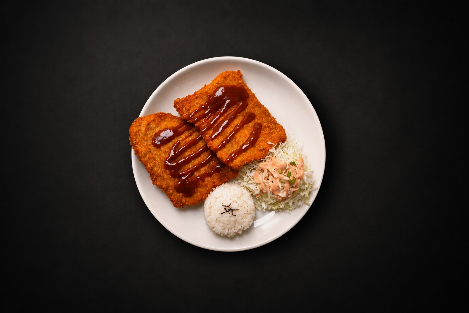 Sliced breaded cutlet with sauce, rice, and salad