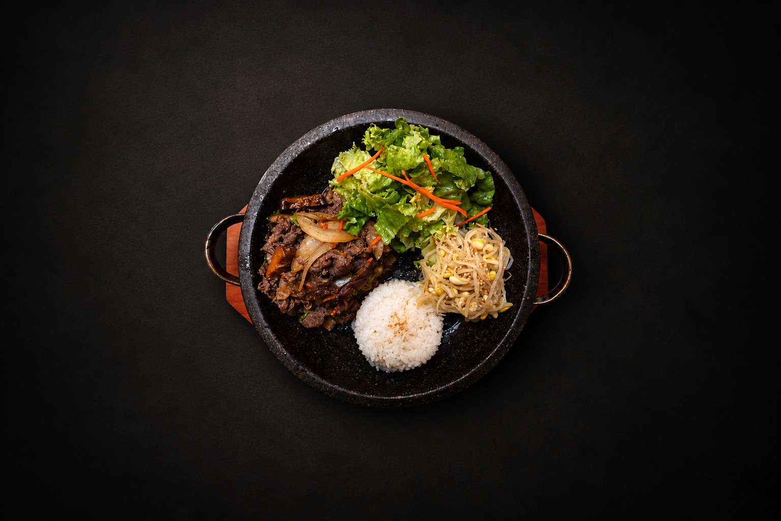Rice, vegetables, and meat arranged in a dark bowl
