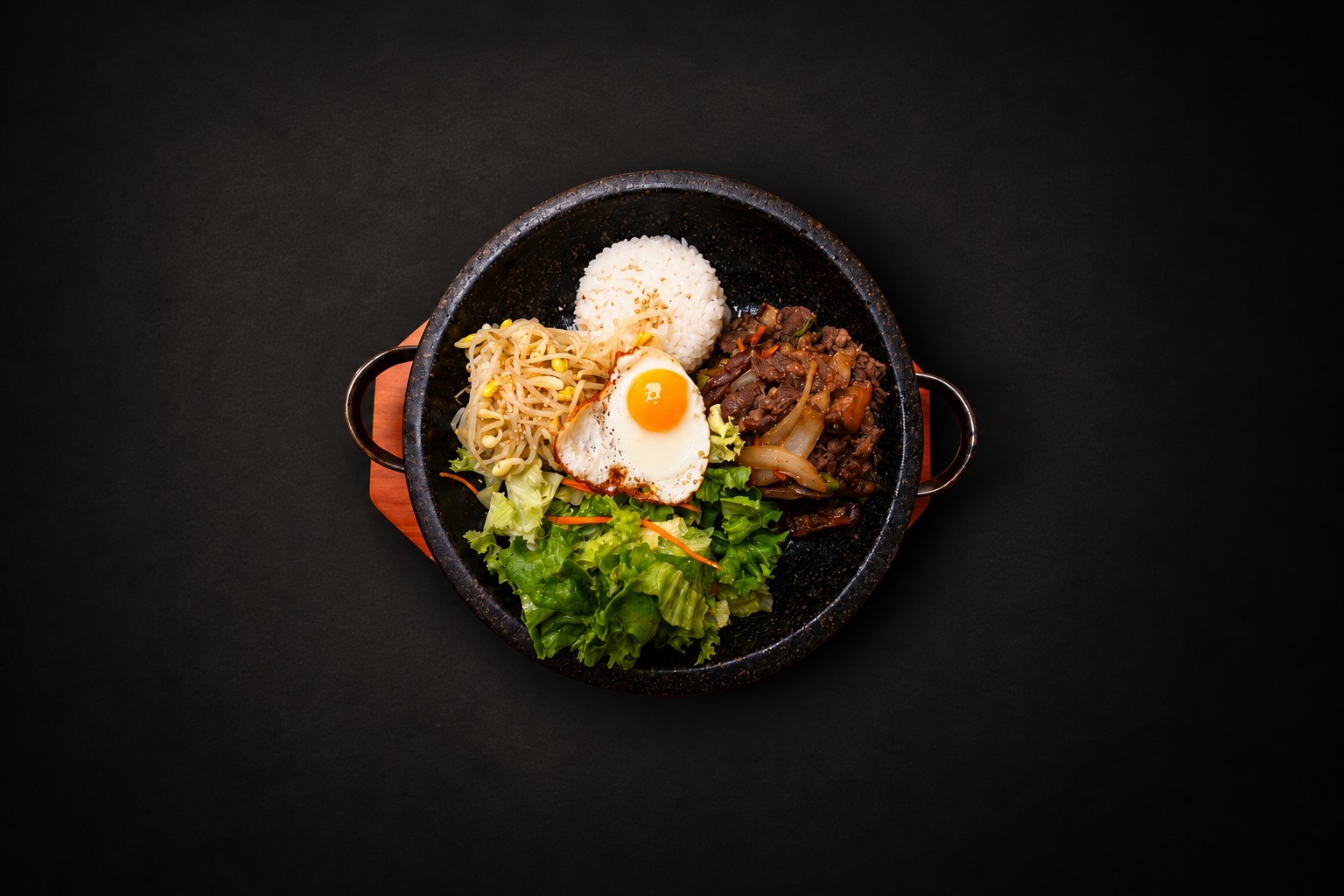 Rice, vegetables, and meat arranged in a dark bowl