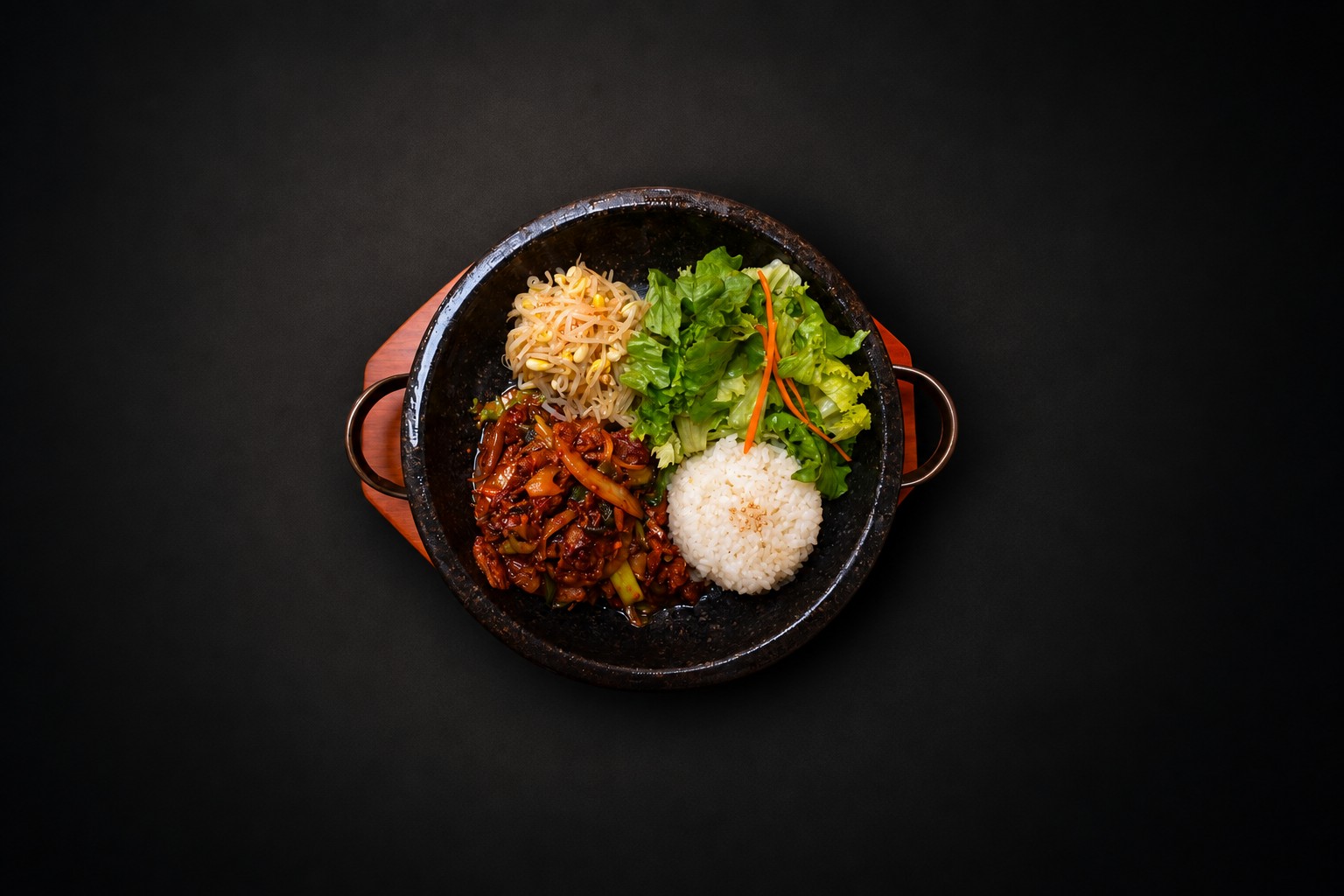 Rice, vegetables, and meat arranged in a dark bowl