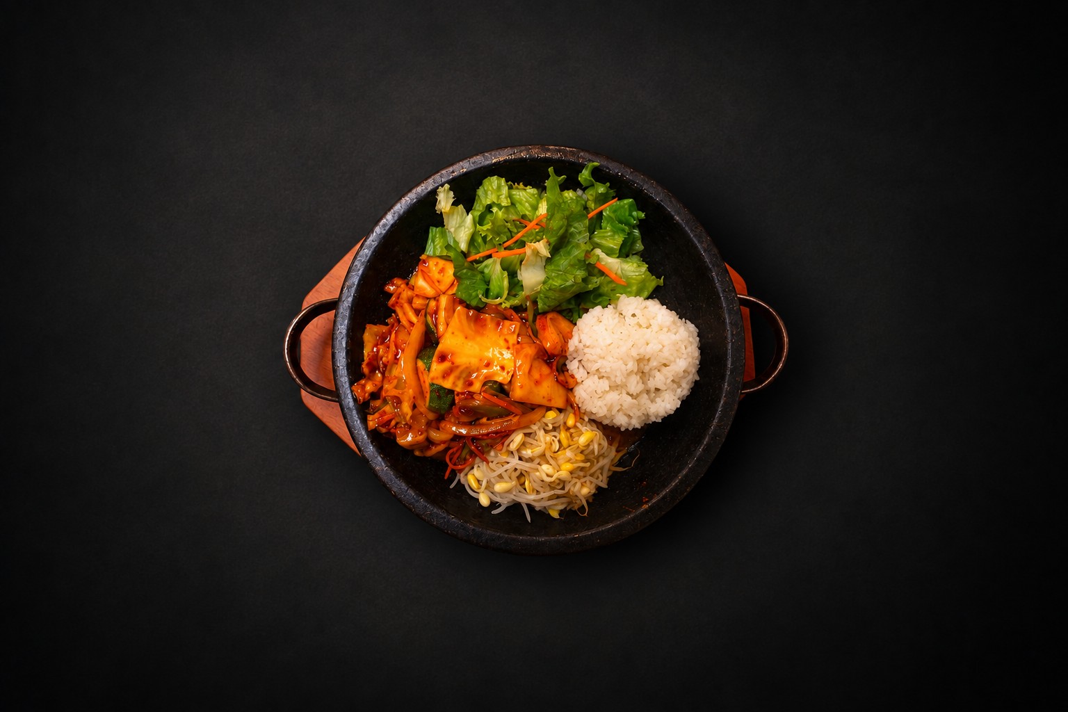 Rice, vegetables, and meat arranged in a dark bowl