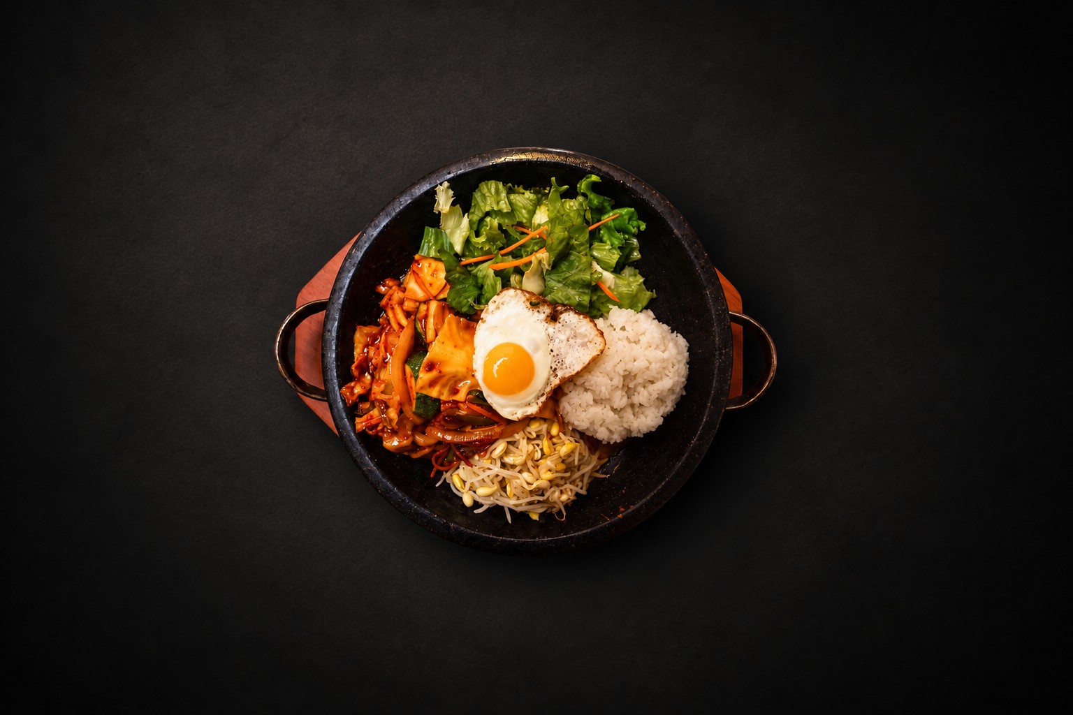 Rice, vegetables, and meat arranged in a dark bowl