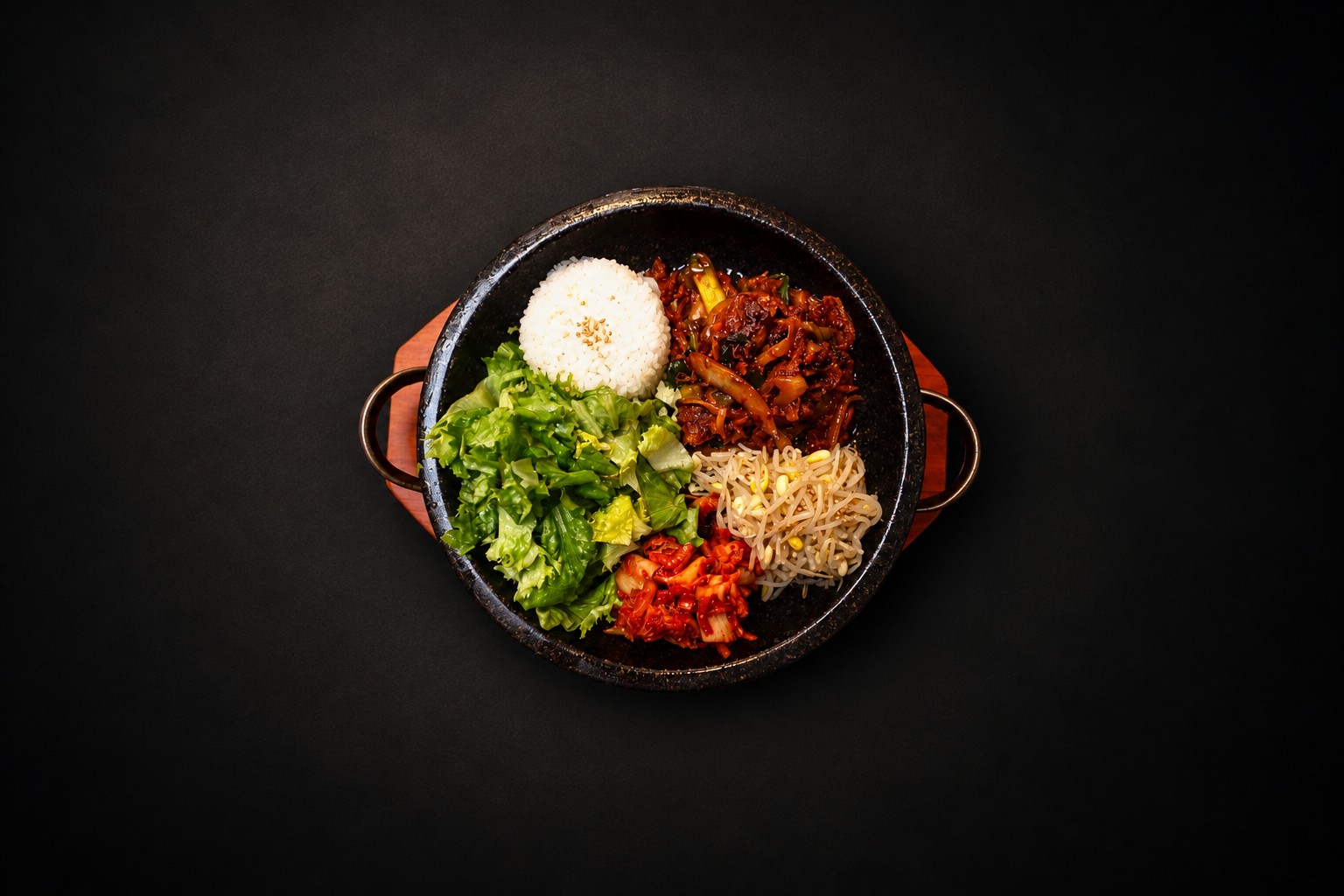 Rice, vegetables, and meat arranged in a dark bowl