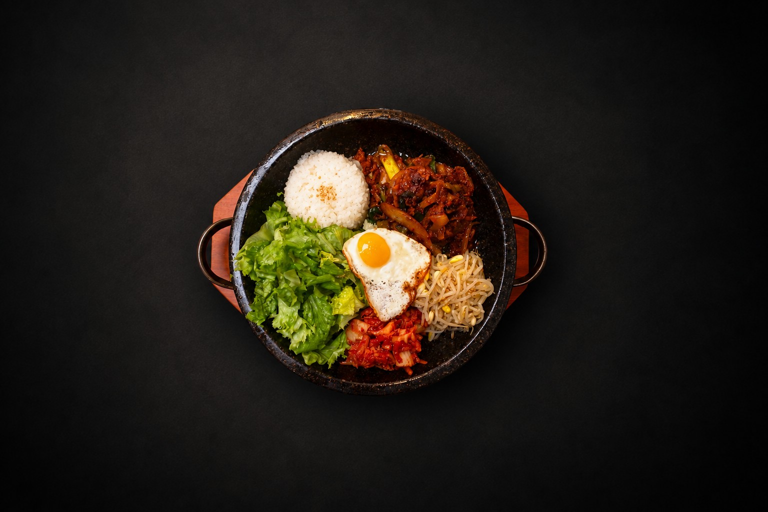 Rice, vegetables, and meat arranged in a dark bowl